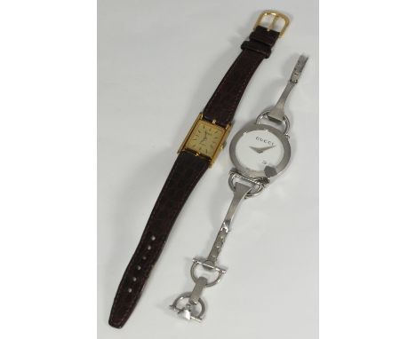 A white metal ladies Gucci bracelet watch together with a ladies Tissot watch with rectangular gilt dial and brown leather st