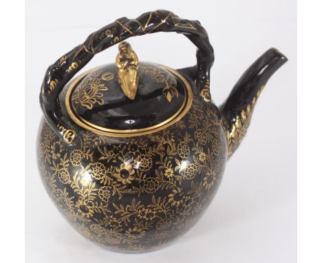 A 19th century Wedgwood ceramic teapot, finished in black with a gold floral design and gilt figural moulded handle to lid, w