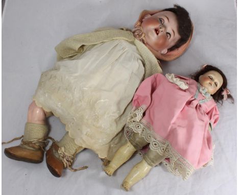 A Heubach Koppelsdorf 320 bisque headed doll and another smaller porcelain headed doll 
