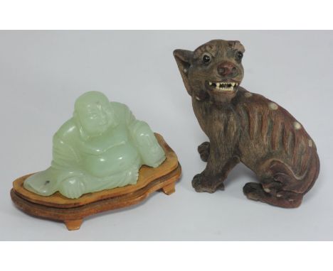 A green jade happy Buddha seated on wooden plinth,  approx. 5cm high, together with a composite dog of fo (af) (2) 