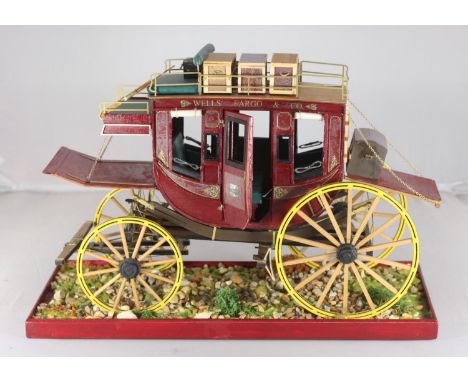 A scratch built wooden model of the 19th century Wells Fargo &amp; Co. horse-drawn stagecoach, with luggage to top and uphols