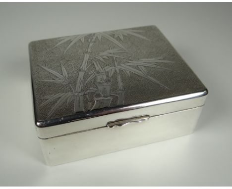 A HONG KONG SILVER CIGARETTE BOX the lid with bamboo decoration to a textured surround, Tackhing silver mark to base, 10cms w