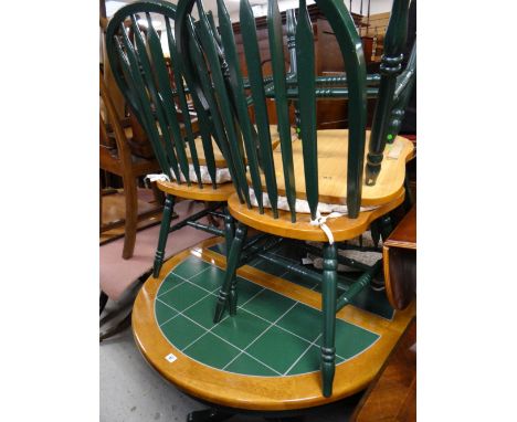 A circular / oval tile top kitchen table & four chairs