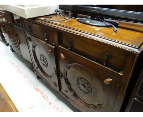 A carved two-door & two-drawer vintage oak sideboard 