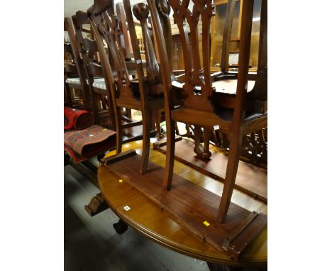 An oval extending mahogany dining table (two leaves) & four Chippendale-style carved back chairs on ball & claw supports
