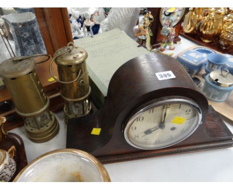 A vintage Napoleon hat mahogany mantel clock together with two reproduction miners lamps