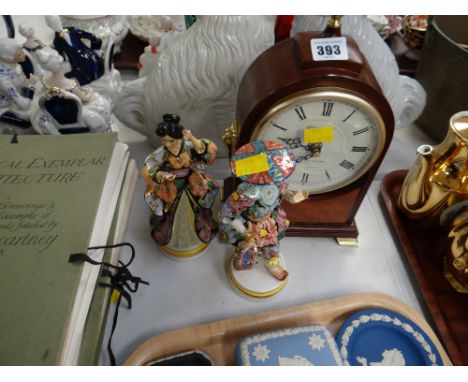 A modern Churchill Westminster chime mantel clock together with two continental figures