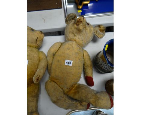 A vintage store stuffed teddy bear with the head moving left to right & with red paw pads