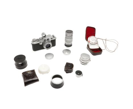A Leica IIIF 'red dial' rangefinder camera, circa 1951/1952 and serial number 587185, with a Leitz Elmar f=5cm, 1:2.8 lens (s