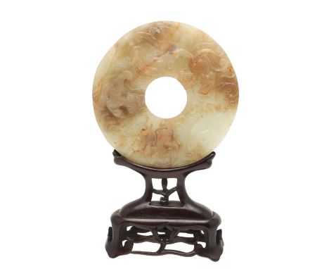 A 20thc copy of a Han Dynasty jade bi disc, carved to one side with chilong in low relief, the reverse with repeating carved 