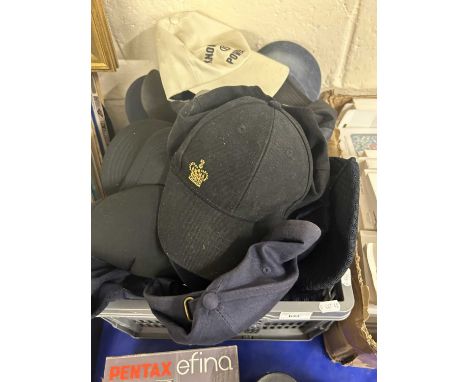 Box of various baseball caps and other head wear