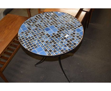 A modern tile top and metal framed table