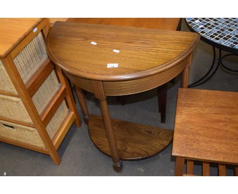 An Ercol light elm half moon hall table