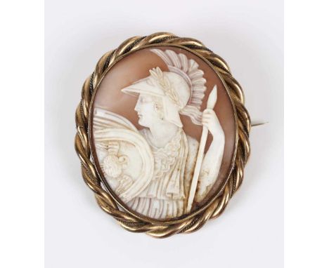 A Victorian gilt metal mounted oval shell cameo brooch, carved as a portrait of Athena in armour, width 4.6cm.