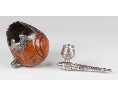 A South American silver mounted nut bowl, the mounts with niello work decoration, length 11.2cm, and a South American white m