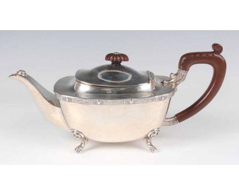 A George VI silver teapot of curved rectangular form with cast Celtic band, on scroll feet, Birmingham 1948 by Charles S. Gre
