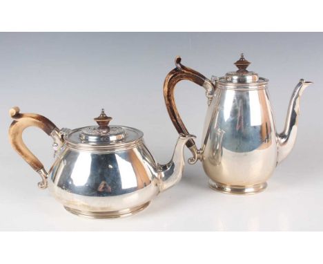 An Elizabeth II silver teapot and matching coffee pot, each of squat circular form with cast blind fretwork hinged lid, on a 