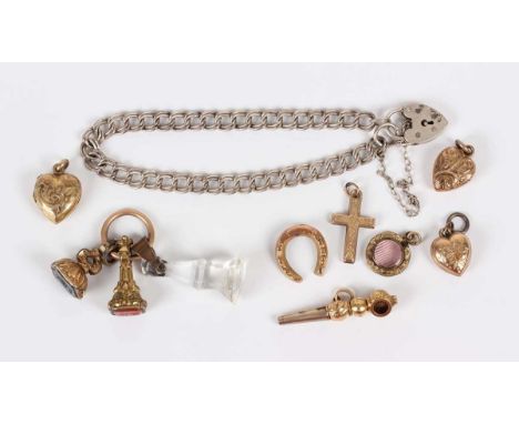 A small group of charms, including a gilt metal and bloodstone fob seal, carved as a butterfly, length 1.7cm, a gilt metal an