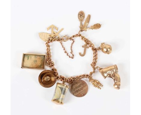 A 9ct gold curblink charm bracelet on a boltring clasp, fitted with seven 9ct gold charms, including a boot and a cup and sau