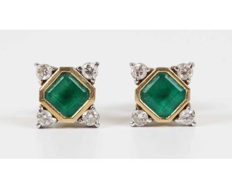 A pair of two colour gold, emerald and diamond earstuds, each mounted with a cut cornered square step cut emerald within a su