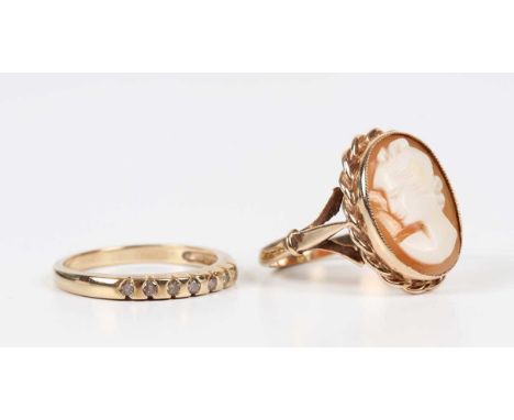 A 9ct gold ring, mounted with an oval shell cameo, carved as a portrait of a lady, within a ribbon twist surround, Birmingham