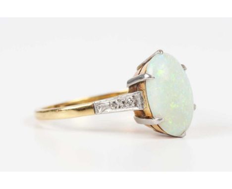 A gold and platinum ring, claw set with an oval opal between diamond two stone shoulders, detailed ‘18ct Plat’, weight 4.2g, 