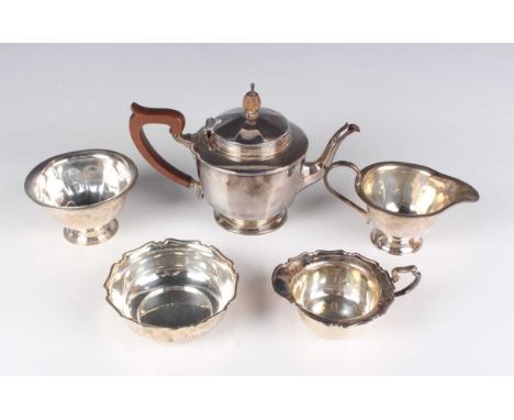 A George V silver teapot of faceted circular form, initial engraved, on a circular foot, Birmingham 1929 by Wilson &amp; Shar