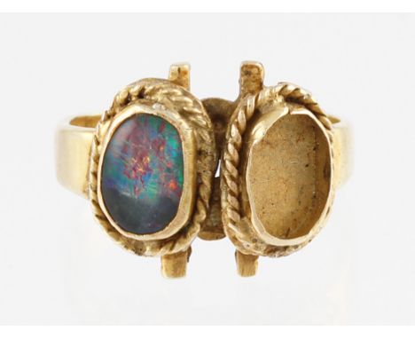 A yellow metal opal doublet ring, rub over set with an opal doublet measuring approx. 8x5mm, with space for another (stone mi