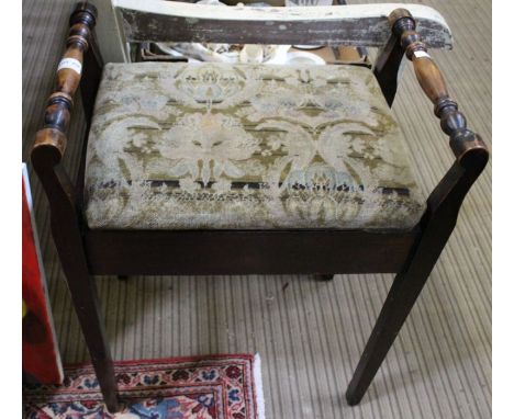 A tapestry topped lift lid piano stool.