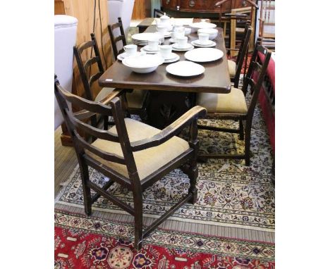 Reproduction oak rectangular topped refectory table, with shaped and pierced plank supports, united by a pegged stretcher wit
