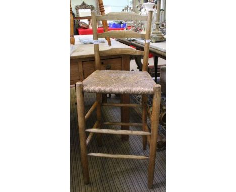 A child's ladder back tall rush seated chair.