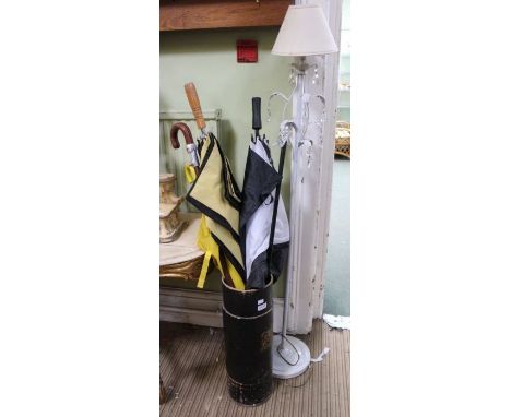 A cardboard stick stand with contents, having decorative crest, together with a white metal standard lamp