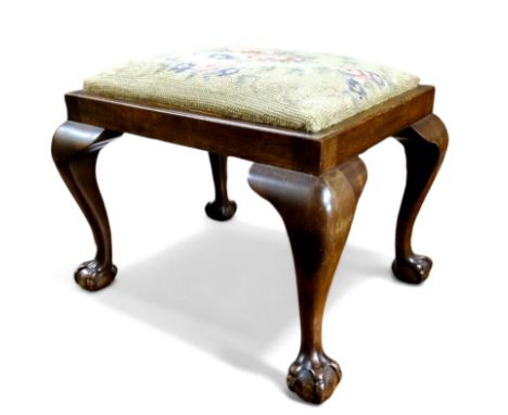 A late 19th century mahogany footstool, needlepoint tapestry seat, cabriole legs terminating with ball and claw feet, 29cm x 