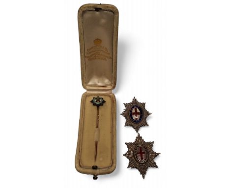 An Irish Guards stick pin, white and yellow metal, eight pointed St. Patrick’s Star, centred saltire and clover leaf, bordere