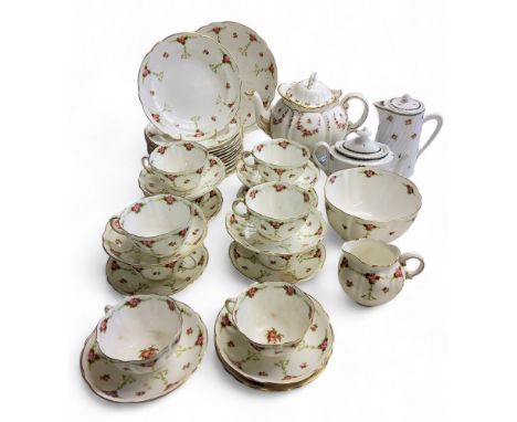An English bone chine tea service, decorated with scattered roses;&nbsp; a a Maple and Co teapot, with rose swags, printed mr