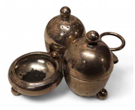 An unusual Victorian silver condiment set, comprising pepperette, salt and mustard pot, missing liners, Harrison Brothers &am