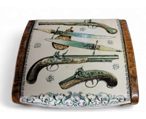 Pierro Fornasetti - a trinket box, the cover lithographed with pistols and knives, faux wooden sides, 10cm wide, c.1950