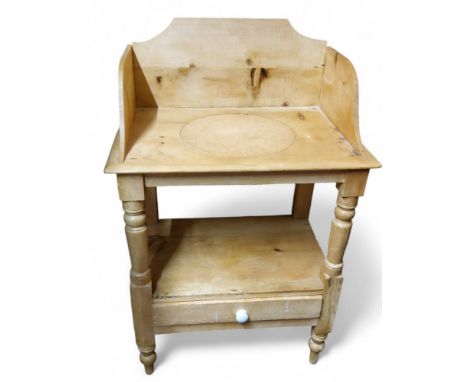 A Victorian pine wash stand, three-quarter gallery, above shelf and drawer, turned legs, 92cm high, 59cm wide, c.1870
