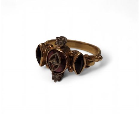 A early 19th century yellow metal, ruby &amp; diamond ring, the central collet set oval ruby surmounted with a white metal wi