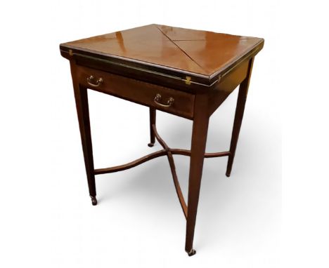 A late Victorian/Edwardian mahogany envelope card table, satinwood crossbanded, ebony strung, drawer to frieze,&nbsp; hinged 