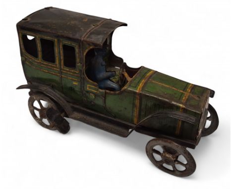 A pre-war French tinplate clockwork vintage car with chauffeur, green body, yellow highlights, black roof, wings and running 