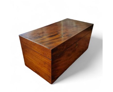 A 19th century mahogany rectangular tea caddy, central mixing bowl aperture flanked by two lidded boxes, 14cm high, 29cm wide