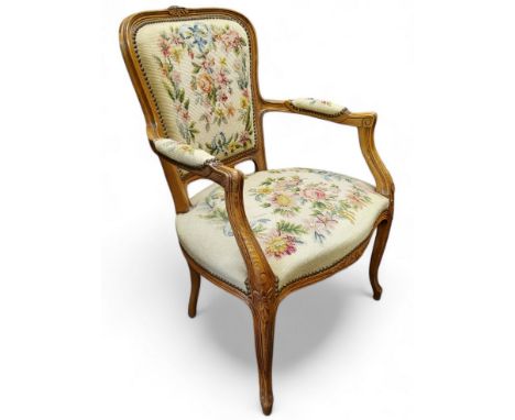 A carved French fauteuil bedroom chair, studded tapestry upholstery, cabriole legs, French pad foot, seat height 42cm