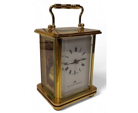 A Swiss brass carriage clock, eleven jewel unadjusted movement, signed Matthew Norman, Switzerland, no. 1754, white enamel di