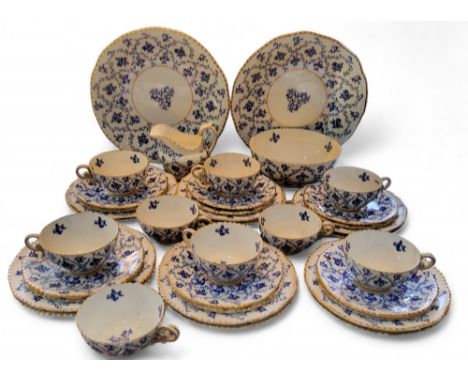 A Coalport tea service, comprising two bread and butter plates, sugar bowl, milk jug, twelve side plates and saucers, nine cu