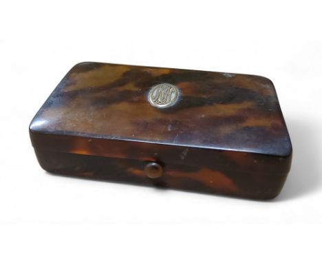 An early 20th century faux tortoiseshell trinket box, gold coloured metal monogramed cartouche, 12cm wide, c.1910
