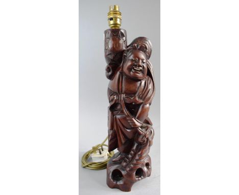 A Carved Chinese Hardwood Figural Table Lamp Stand in the Form of Smiling Immortal, 43cm High 