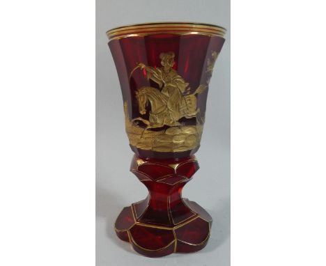 A Good Bohemian Gilt Overlaid Ruby Glass Goblet decorated with Mounted Turkish Soldier Riding Away from Christian Village. 18