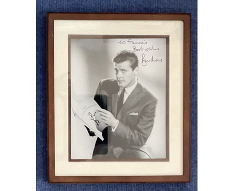 Roger Moore signed 13x12 inch overall framed and mounted black and white vintage Saint photo.. Good condition. All autographs