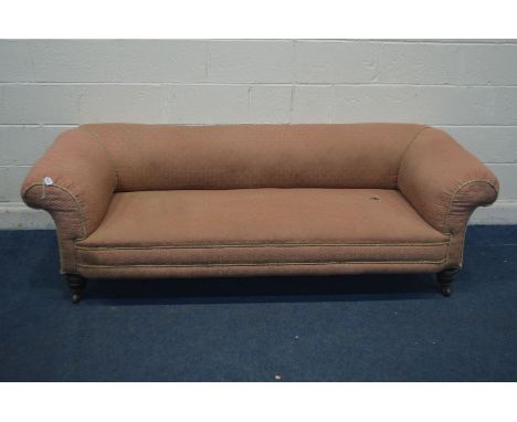 AN EDWARDIAN PINK UPHOLSTERED CHESTERFIELD SOFA, on ceramic casters, width